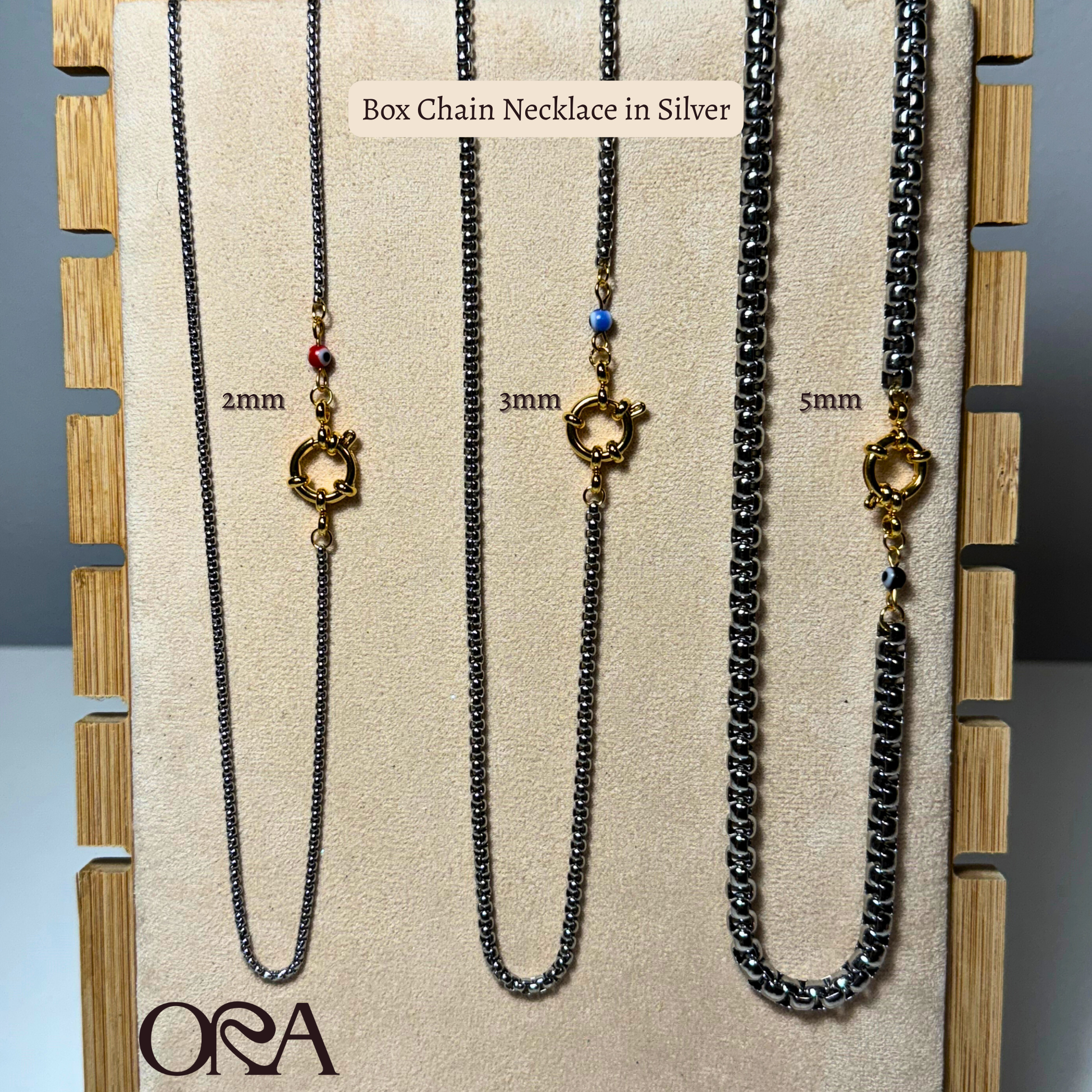 Box chain necklaces in various widths displayed on a branded card with 'ORA' logo.